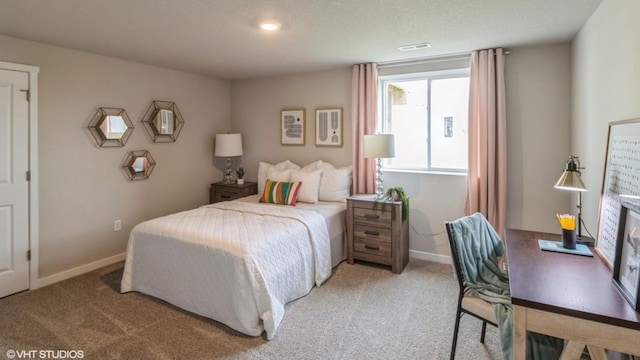 bedroom featuring light colored carpet