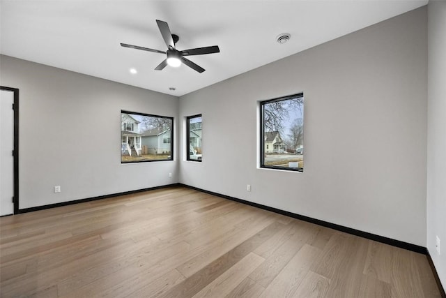 empty room featuring light hardwood / wood-style flooring and ceiling fan