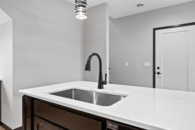 kitchen with dark brown cabinetry and sink