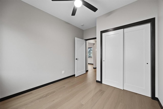 unfurnished bedroom with ceiling fan, a closet, and light hardwood / wood-style floors