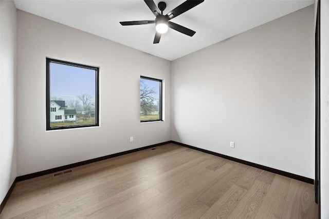 spare room with ceiling fan and light wood-type flooring