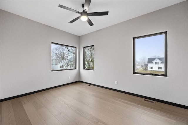 unfurnished room featuring ceiling fan and light hardwood / wood-style flooring