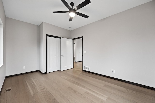 unfurnished bedroom with light hardwood / wood-style floors and ceiling fan