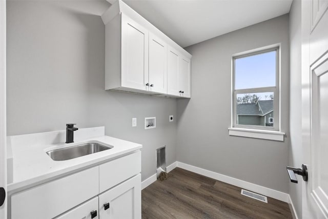 laundry area with electric dryer hookup, cabinets, sink, hookup for a washing machine, and dark hardwood / wood-style flooring