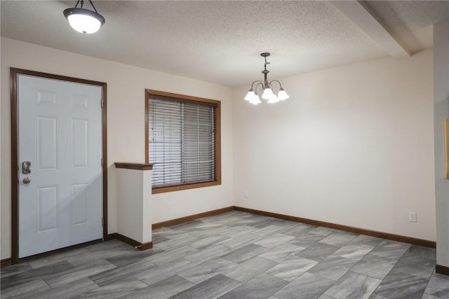 interior space with an inviting chandelier and a textured ceiling