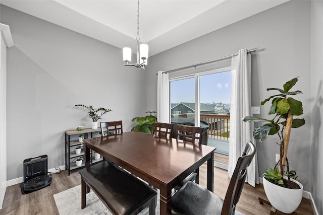 dining room featuring hardwood / wood-style flooring and a notable chandelier