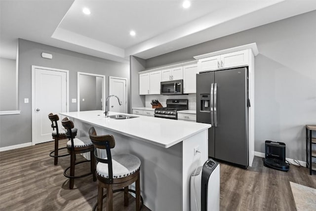 kitchen featuring white cabinetry, sink, an island with sink, and appliances with stainless steel finishes