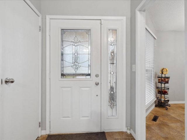 entrance foyer featuring a textured ceiling