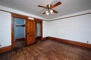 unfurnished bedroom featuring ceiling fan and dark hardwood / wood-style flooring