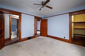 unfurnished bedroom featuring light colored carpet and ceiling fan