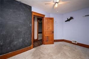 unfurnished bedroom with ceiling fan and carpet floors