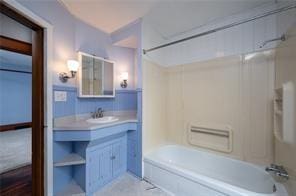 bathroom featuring vanity and shower / washtub combination