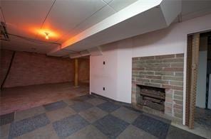 basement with a brick fireplace