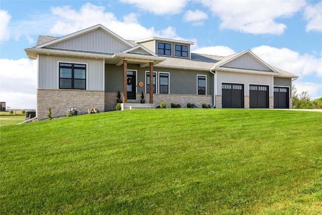 craftsman inspired home featuring a garage and a front lawn