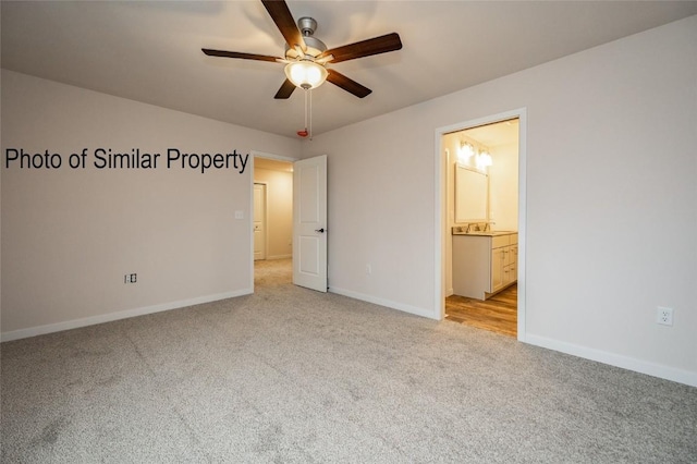 unfurnished bedroom featuring ceiling fan, light colored carpet, sink, and connected bathroom