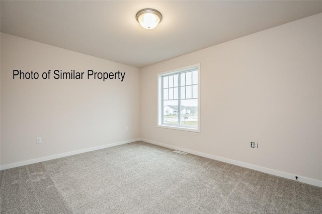 spare room featuring carpet floors