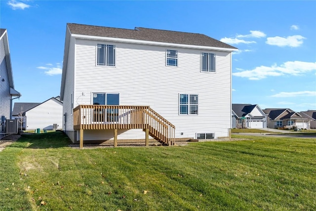 rear view of property with a yard, central AC unit, and a deck