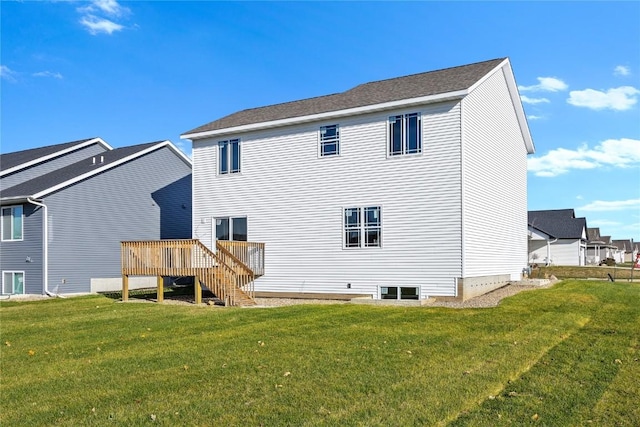 back of property featuring a yard and a deck