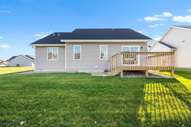 rear view of property with a lawn and a wooden deck