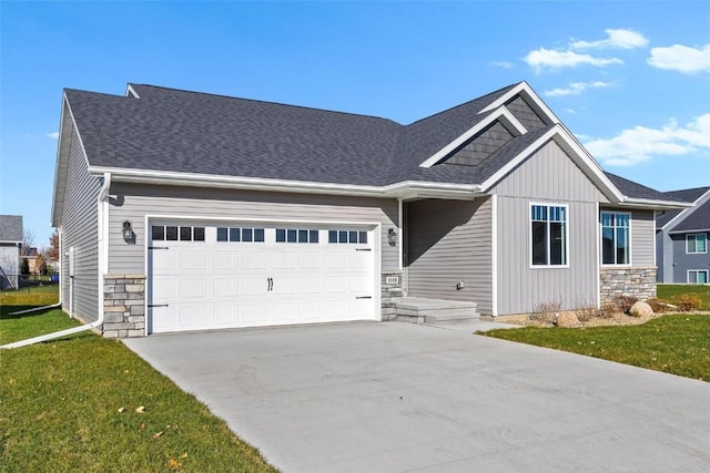 craftsman-style house featuring a front yard and a garage