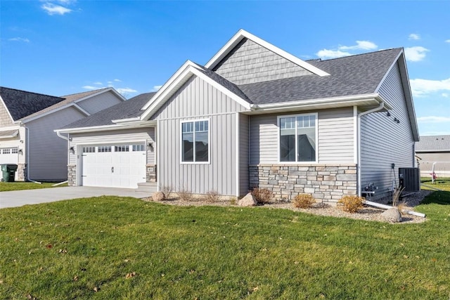 view of front of house with central AC unit, a garage, and a front yard