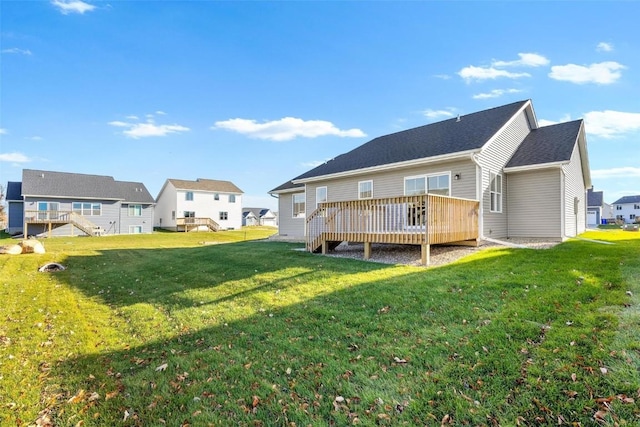 back of property featuring a yard and a deck