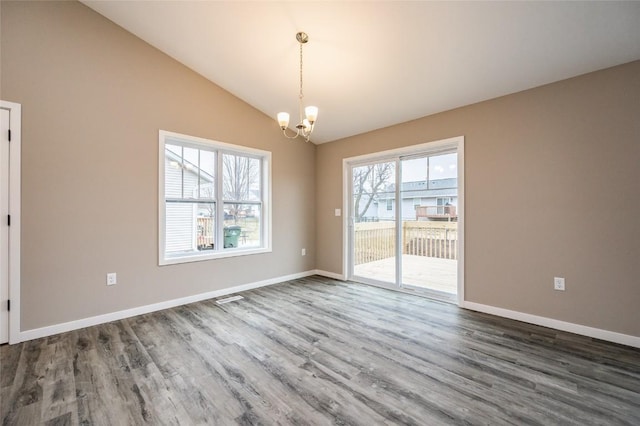 unfurnished dining area with a notable chandelier, dark hardwood / wood-style flooring, and lofted ceiling