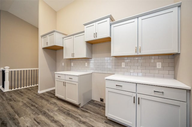 kitchen with tasteful backsplash, dark hardwood / wood-style flooring, and lofted ceiling