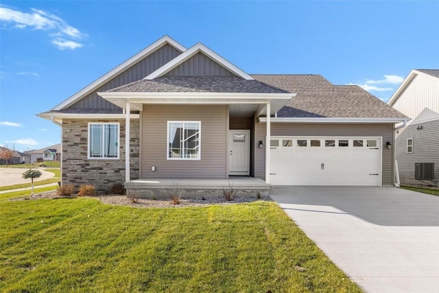 craftsman-style home with a porch, a garage, central air condition unit, and a front yard