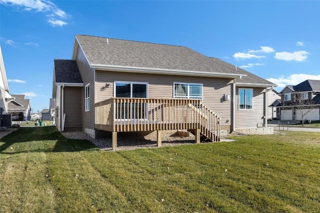 back of property with a yard and a wooden deck