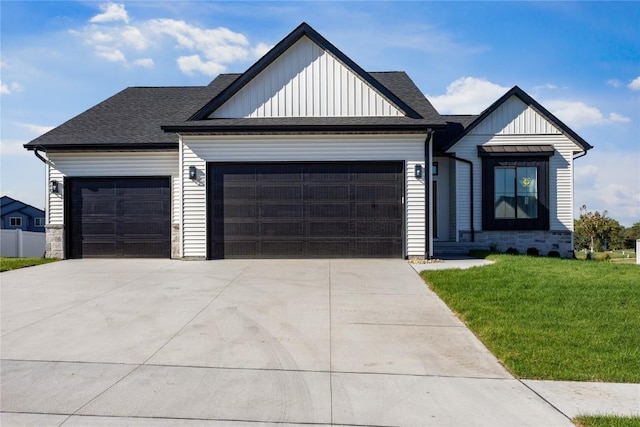 view of front of property with a front yard and a garage