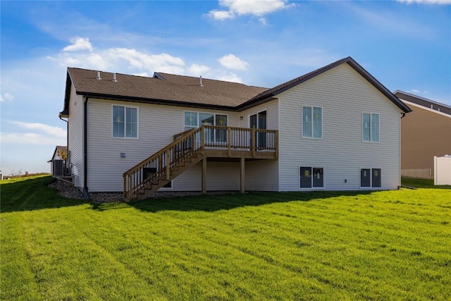 back of house with a deck and a lawn