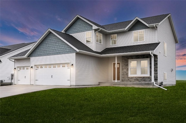 craftsman house featuring a garage and a lawn