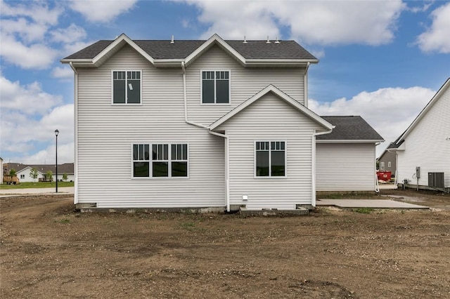 rear view of property with central AC and a patio area