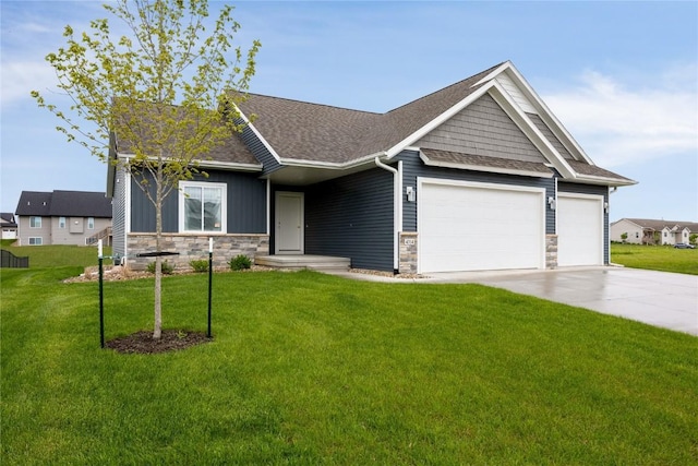 craftsman house with a garage and a front lawn