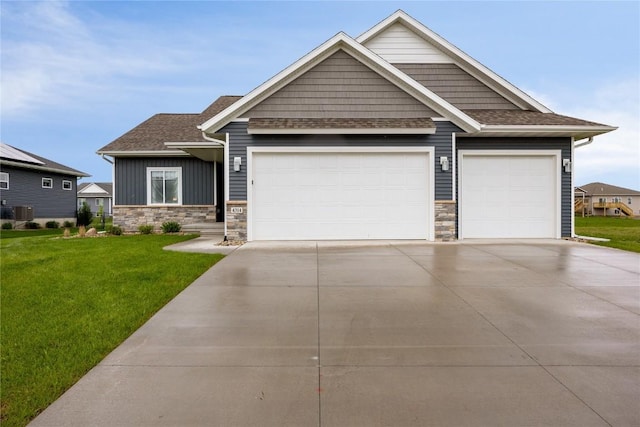 craftsman-style home featuring a front yard, a garage, and cooling unit