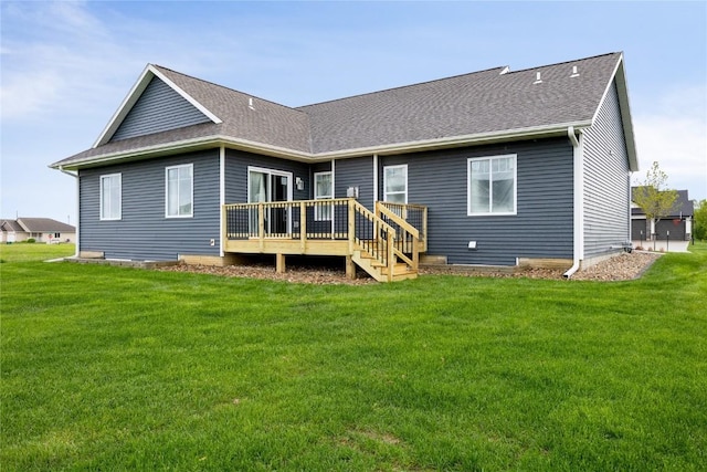 rear view of property with a lawn and a wooden deck