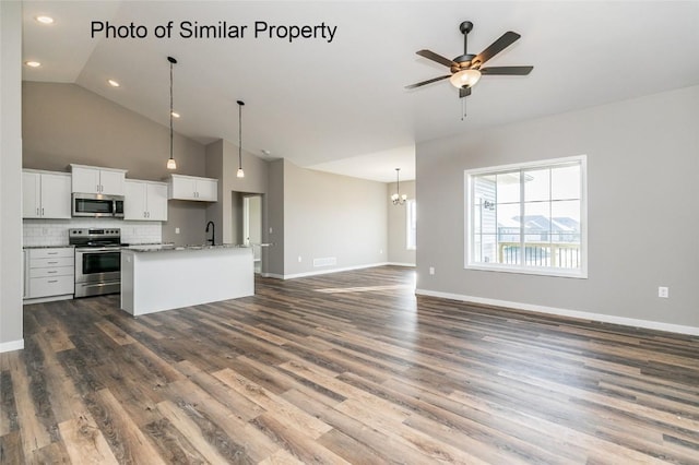 kitchen featuring backsplash, white cabinets, ceiling fan with notable chandelier, decorative light fixtures, and stainless steel appliances