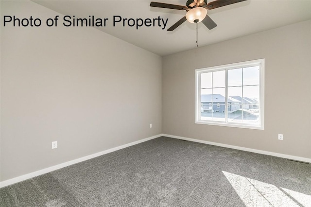 unfurnished room with ceiling fan and carpet