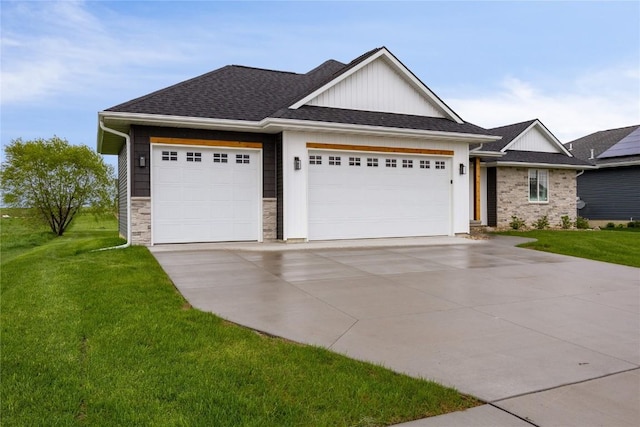 view of front facade with board and batten siding, driveway, a front yard, an attached garage, and a shingled roof