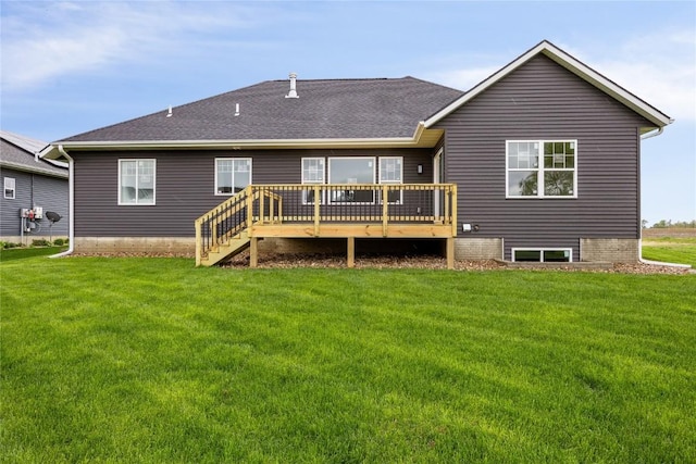 back of property with a wooden deck and a yard