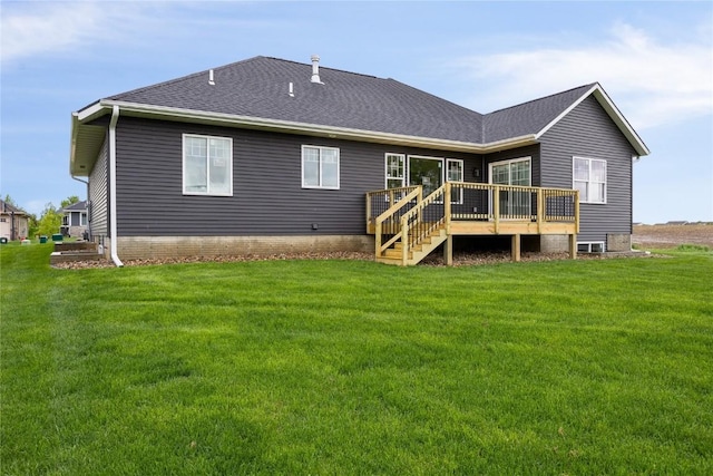 rear view of property featuring a deck and a yard