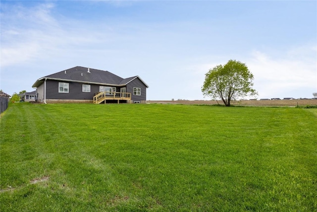 view of yard featuring a rural view and a deck