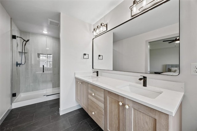 bathroom featuring a sink, baseboards, a stall shower, and visible vents