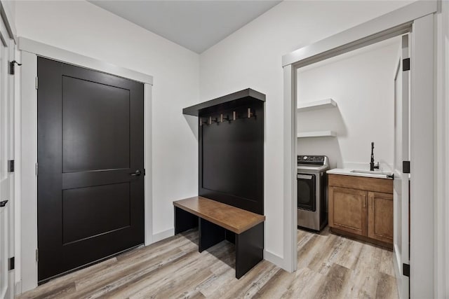 mudroom featuring a sink and light wood-type flooring