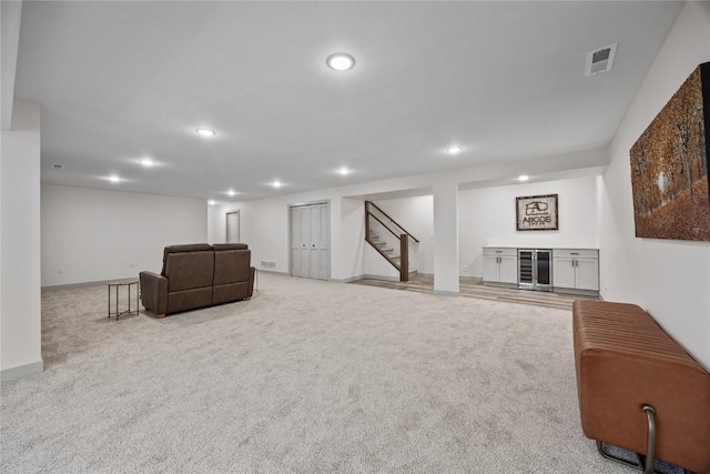 interior space with recessed lighting, wine cooler, visible vents, a bar, and stairway