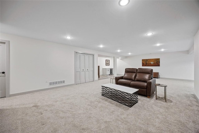 living room with visible vents, carpet flooring, and recessed lighting