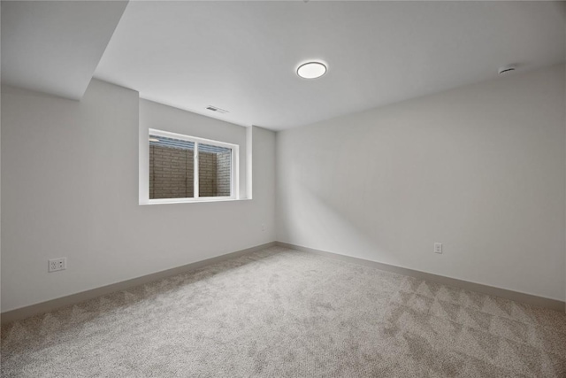 unfurnished room with carpet floors, baseboards, and visible vents