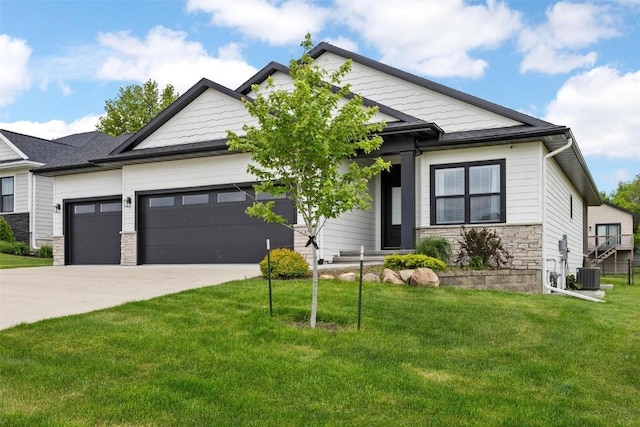 view of front of home with a garage, central air condition unit, and a front yard