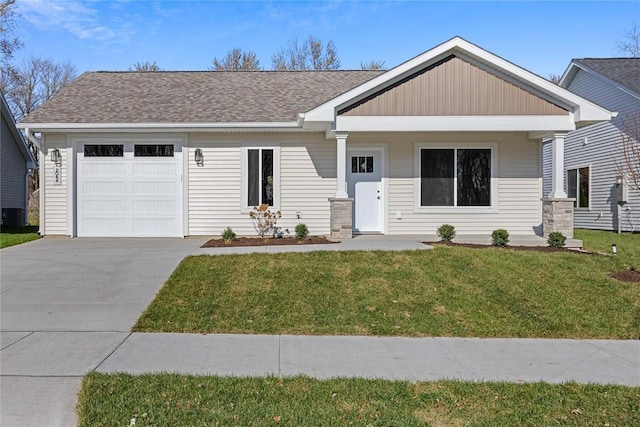 view of front facade featuring a porch, a garage, and a front yard